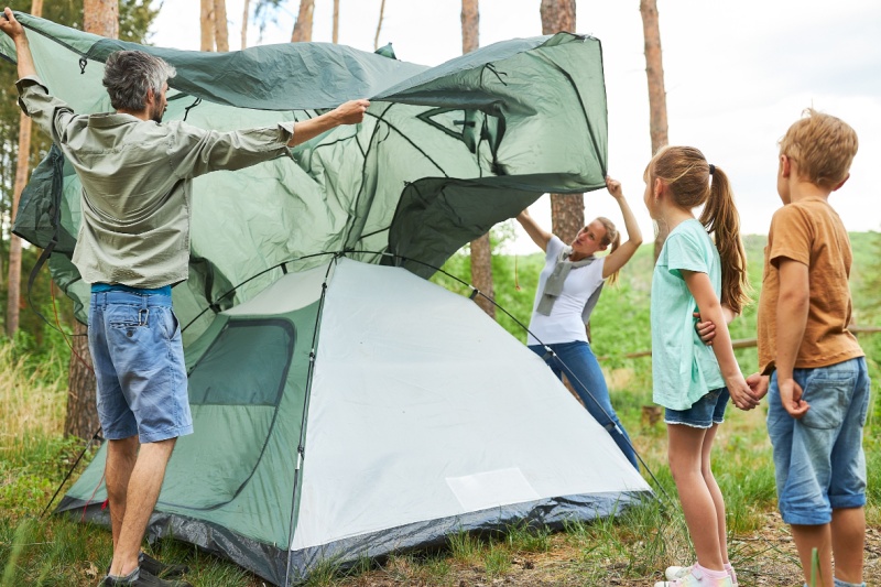 Family setting up a tent